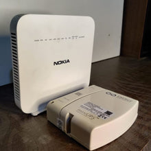 Load image into Gallery viewer, Energy Intelligence router next to a Nokia WiFi router to compare size

